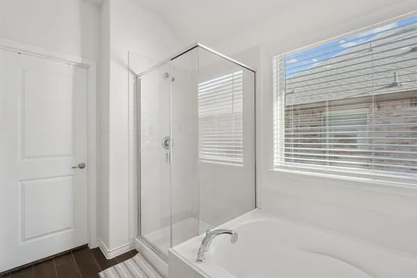 a bathroom with a bathtub and a shower