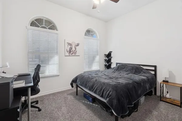 a bedroom with a bed and a desk