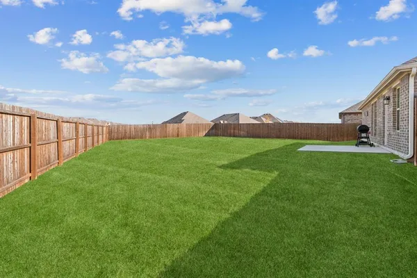 a view of a garden with a building in the background