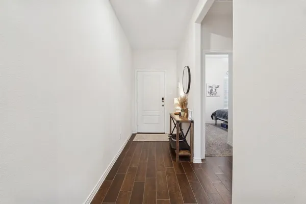 a view of hallway with wooden floor