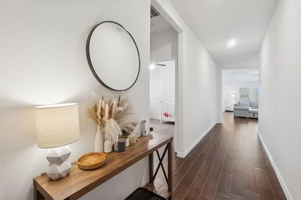 a view of living room with furniture and wooden floor