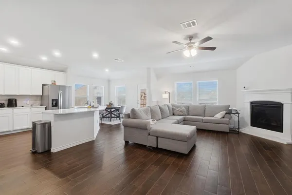 a living room with furniture and a wooden floor