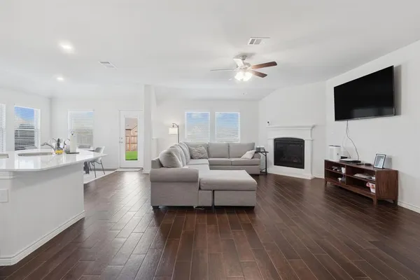 a living room with furniture fireplace and a flat screen tv