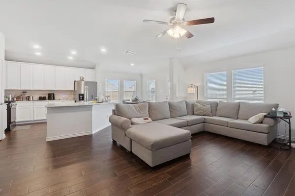 a living room with furniture and kitchen view