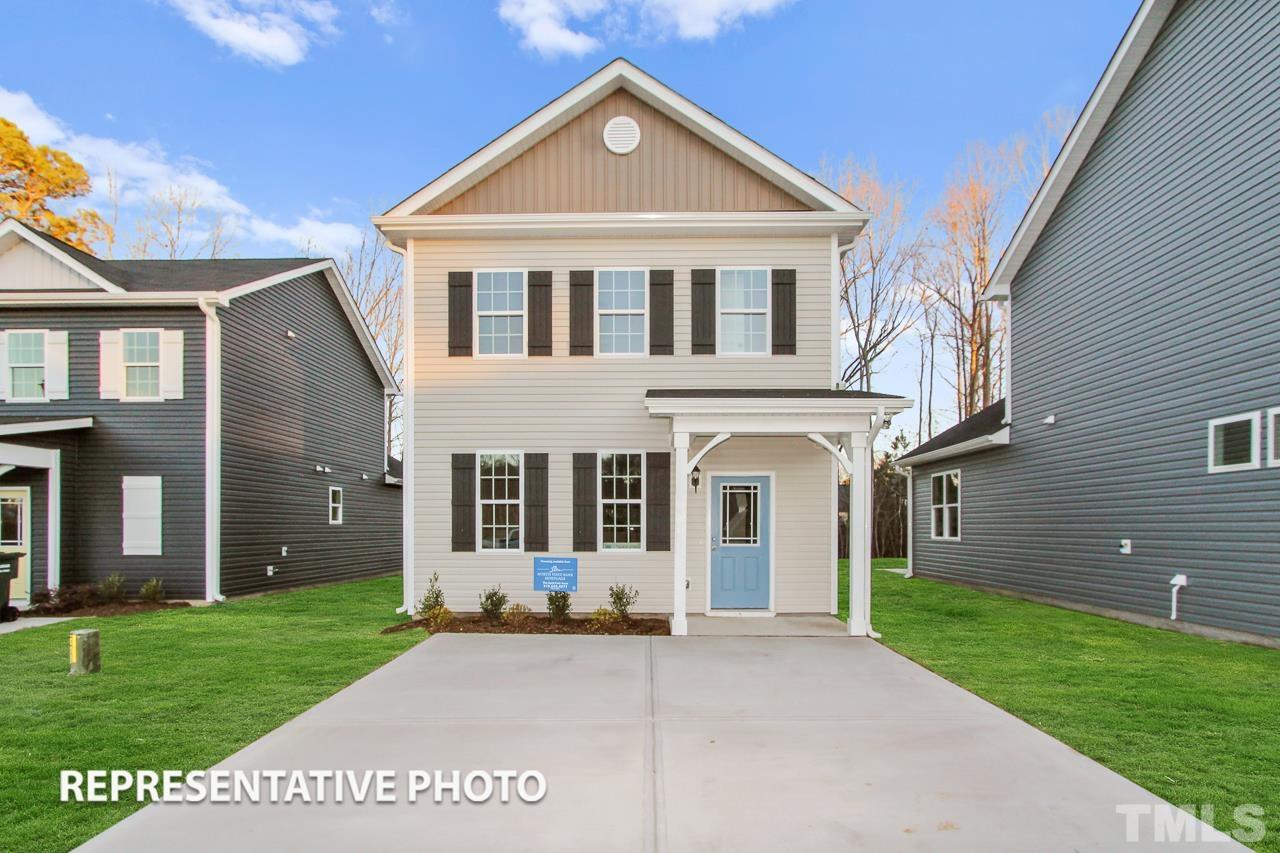 345 Longbow Drive Middlesex, NC 27557 - Photo 1 of 9 a front view of a house with a yard and garage