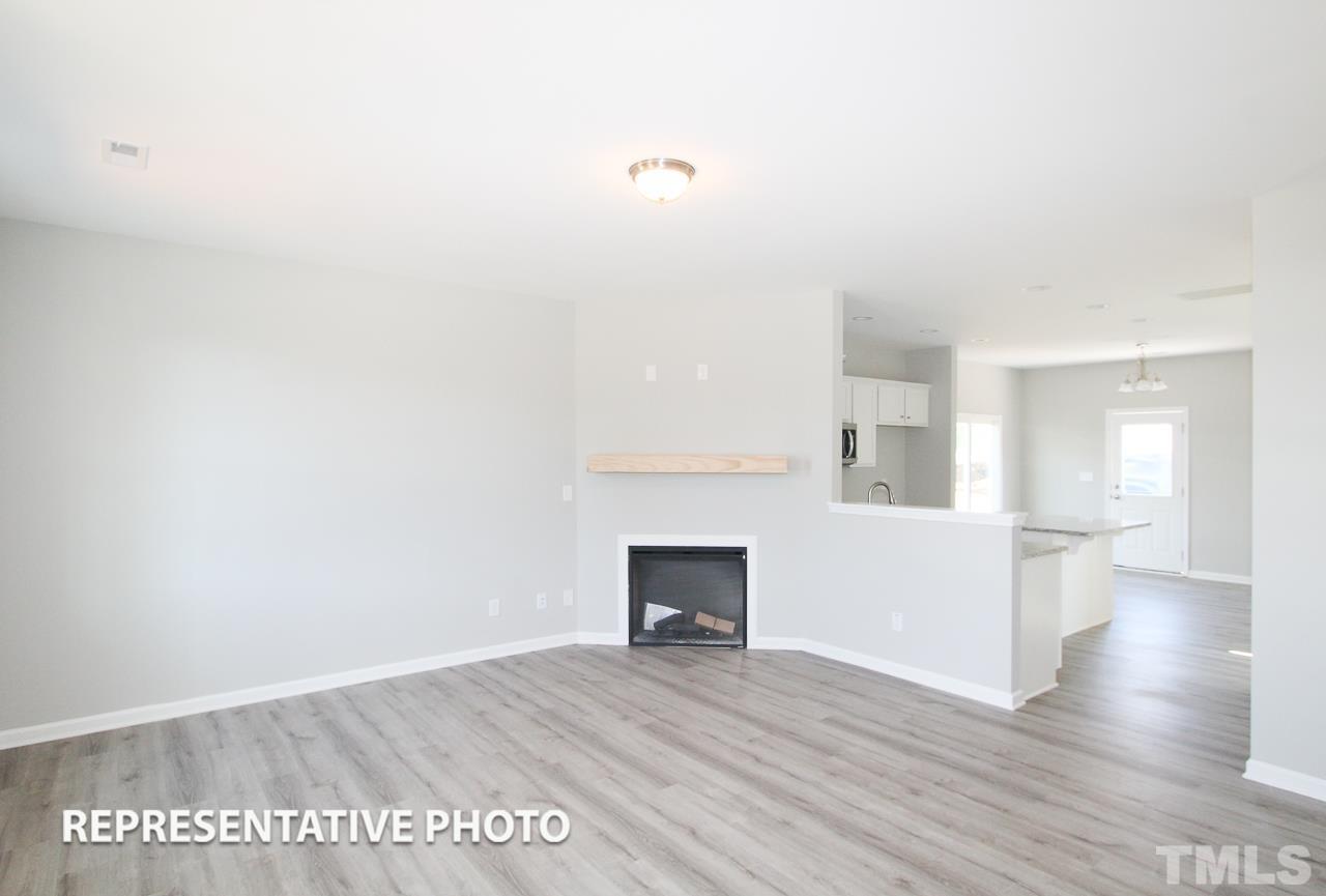 345 Longbow Drive Middlesex, NC 27557 - Photo 5 of 9 a view of a livingroom with wooden floor and a fireplace