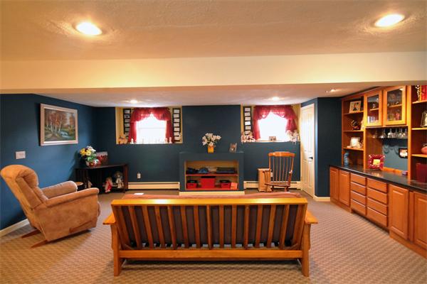 5 Acre Road Billerica, MA 01821 - Photo 20 of 30 a living room with furniture a flat screen tv and a floor to ceiling window