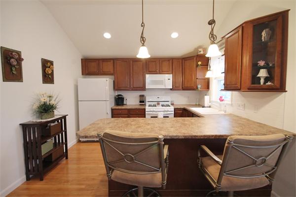5 Acre Road Billerica, MA 01821 - Photo 22 of 30 a kitchen with kitchen island a table chairs refrigerator and microwave