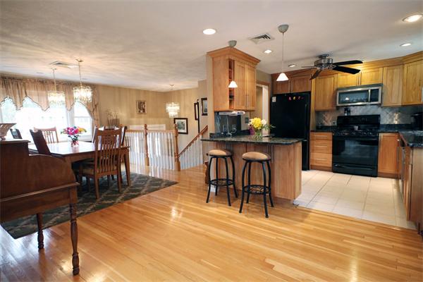 5 Acre Road Billerica, MA 01821 - Photo 5 of 30 a view of a kitchen with stainless steel appliances kitchen island granite countertop a table and chairs in it
