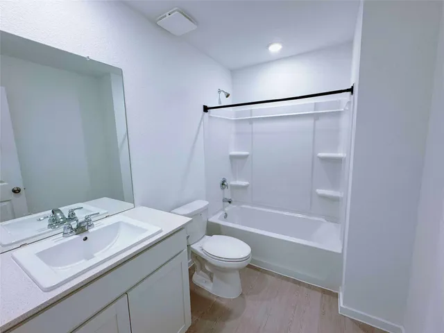 a bathroom with a sink toilet tub and shower