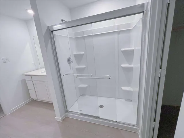 a bathroom with a glass shower door