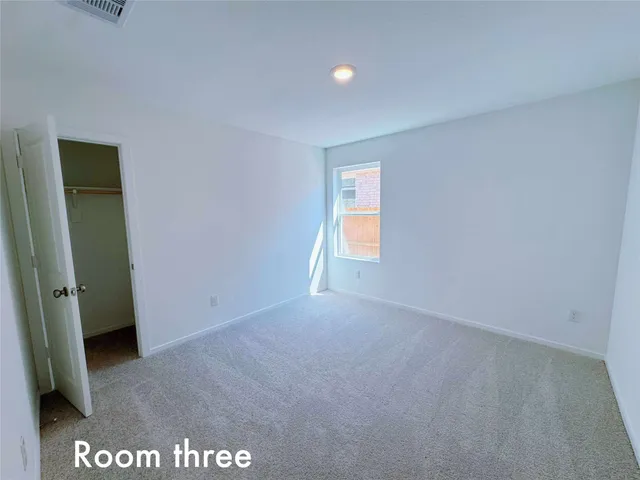 a view of an empty room and a window