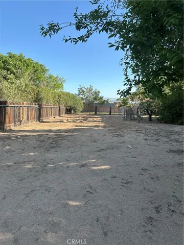 a view of a yard and an empty space