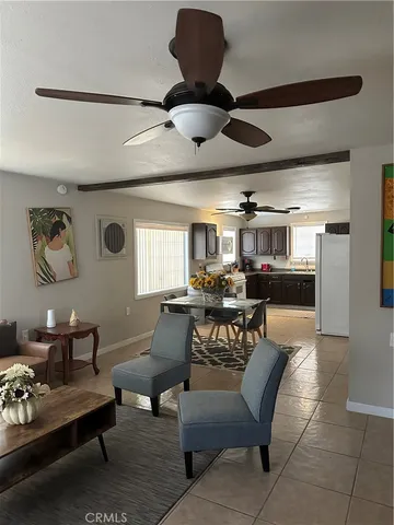a living room with furniture and a ceiling fan
