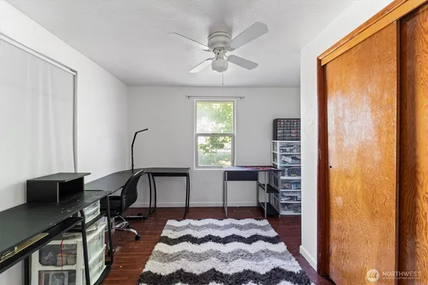 a view of a workspace with furniture and a window