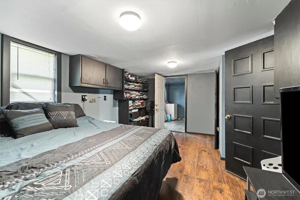 a large bedroom with a bed and a television