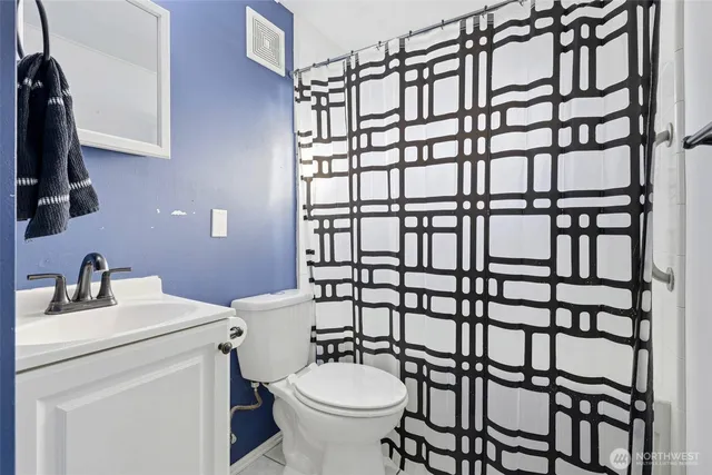 a bathroom with a sink toilet and a mirror