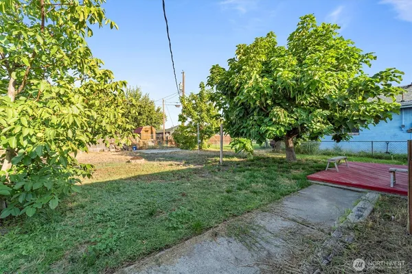 a view of yard with tree in the background