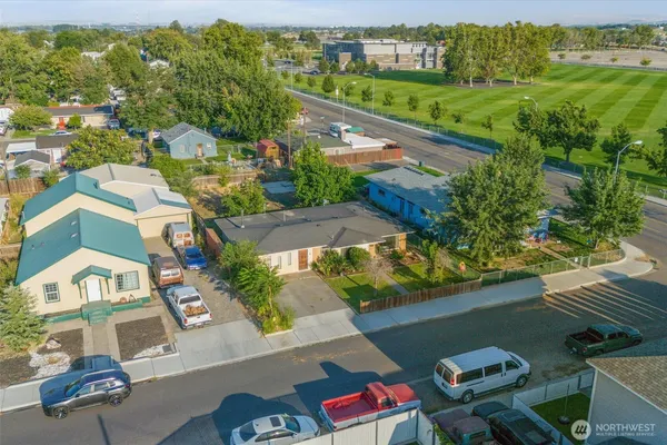 an aerial view of residential houses with outdoor space and street view