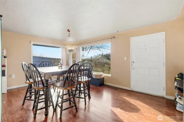 a view of a dining room with furniture window and wooden floor
