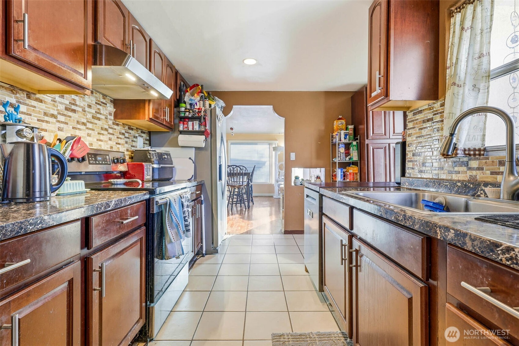 837 South Hawthorne Street Kennewick, WA 99336 - Photo 8 of 18 a kitchen with stainless steel appliances granite countertop a sink and cabinets