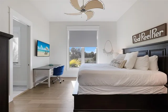 a dining room with furniture large windows and a rug