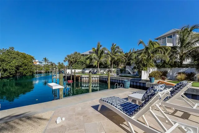 an aerial view of a house with swimming pool and outdoor seating