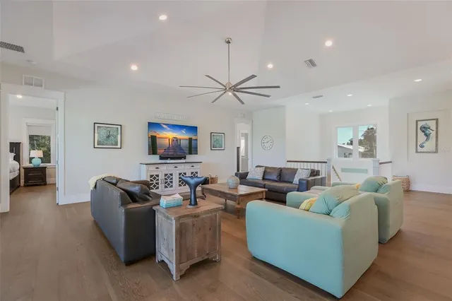 a kitchen with stainless steel appliances granite countertop a stove and a view of living room