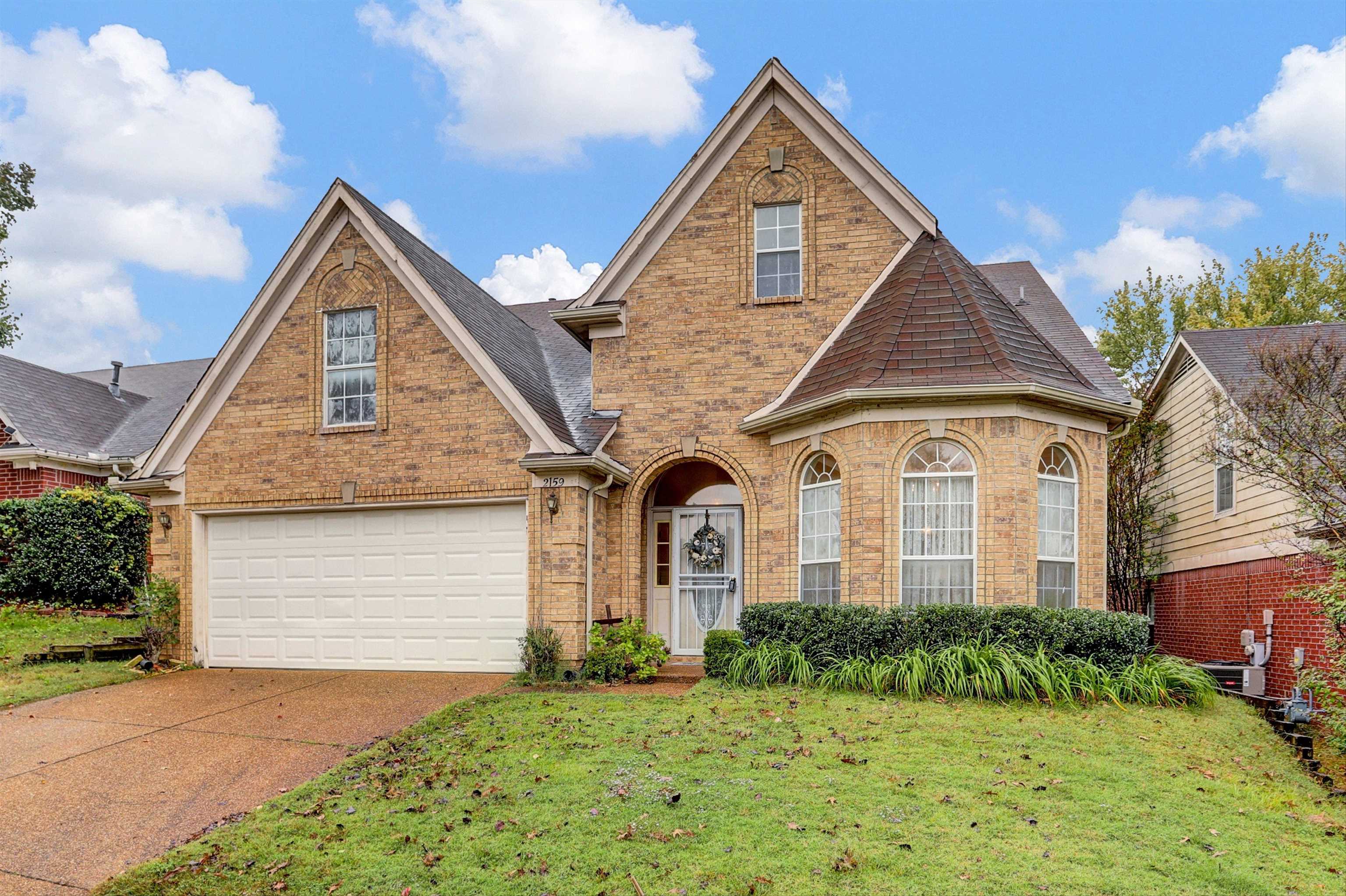 2159 Purple Leaf Lane Memphis, TN 38016 - Photo 1 of 14 a front view of a house with a yard and garage