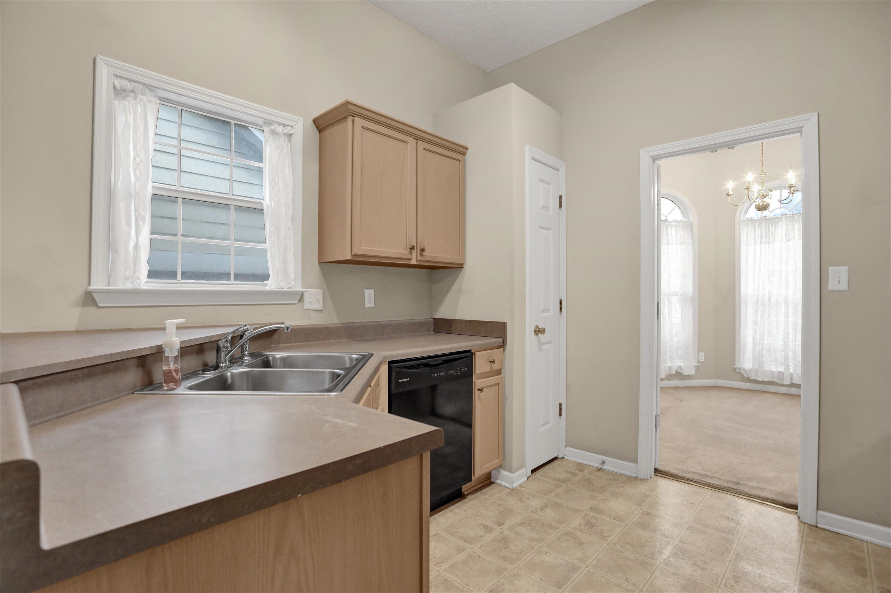 2159 Purple Leaf Lane Memphis, TN 38016 - Photo 5 of 14 a kitchen with a sink cabinets and window
