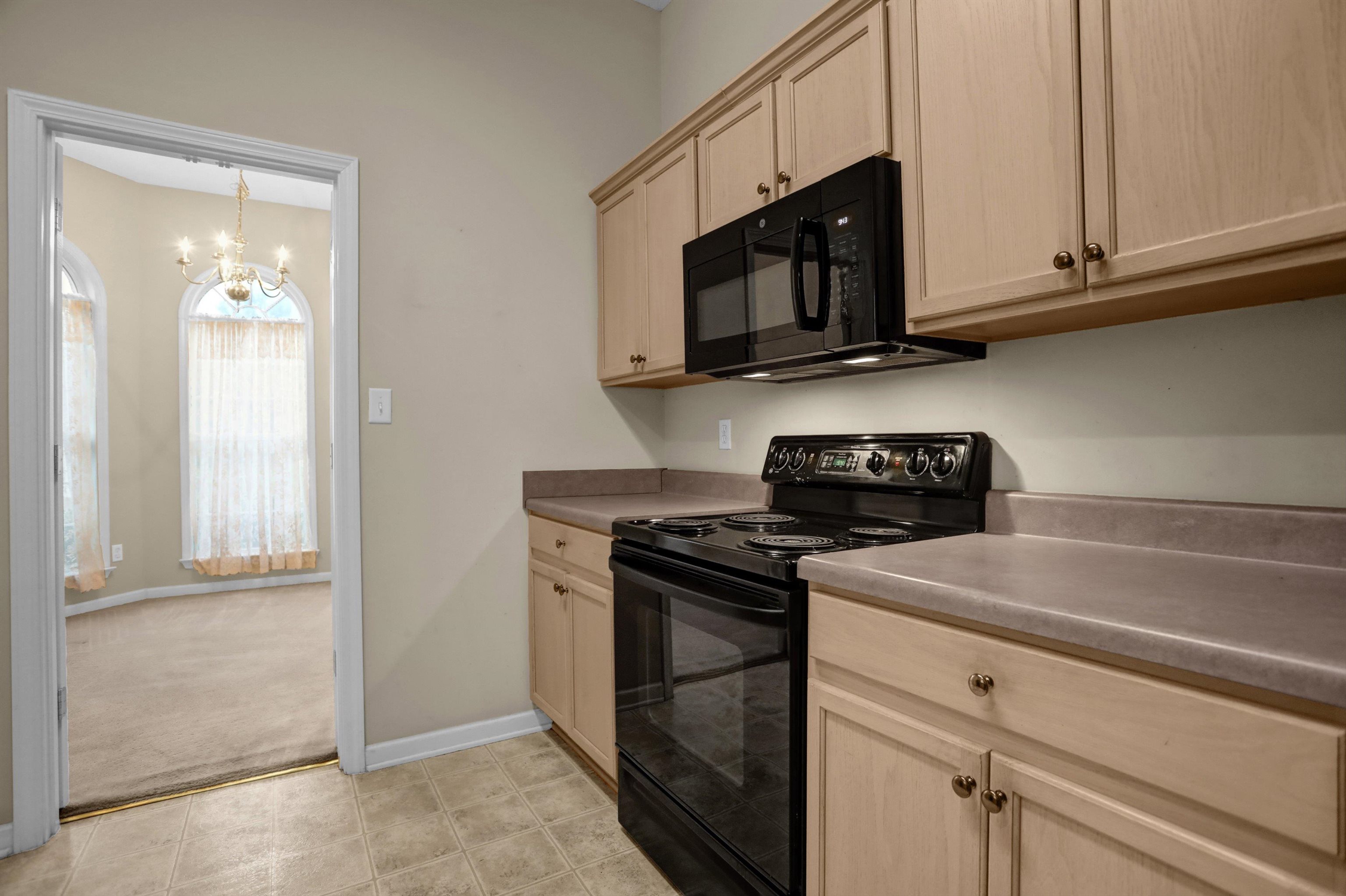 2159 Purple Leaf Lane Memphis, TN 38016 - Photo 6 of 14 a kitchen with stainless steel appliances granite countertop white cabinets and a stove top oven