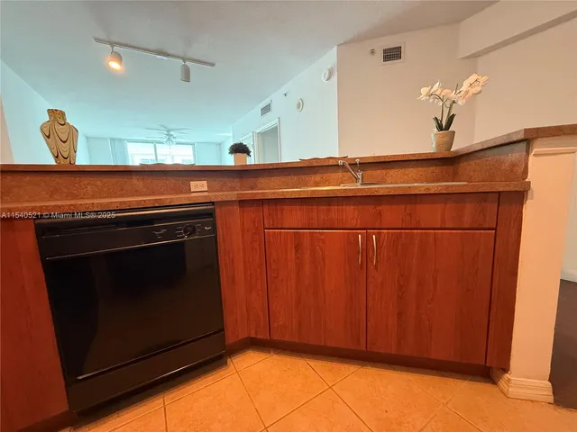 a stove top oven sitting inside of a kitchen