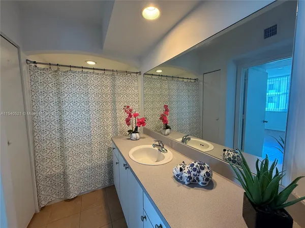 a bathroom with a sink vanity and a mirror