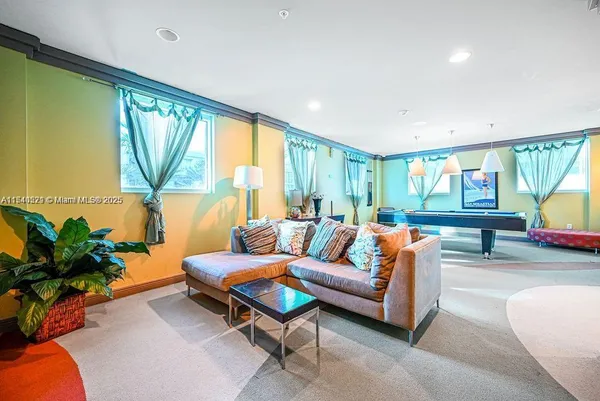a living room with furniture and a large window