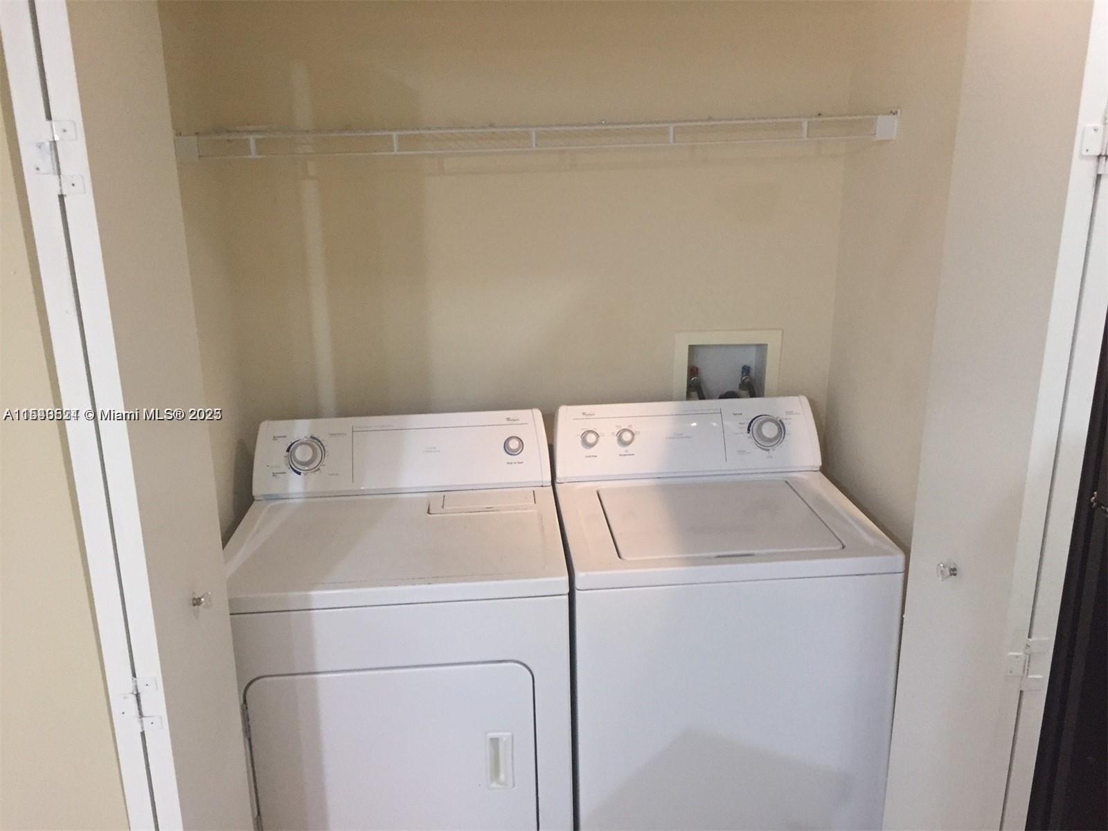 9201 Collins Avenue, Unit 1023 Surfside, FL 33154 - Photo 7 of 28 a utility room with dryer and washer
