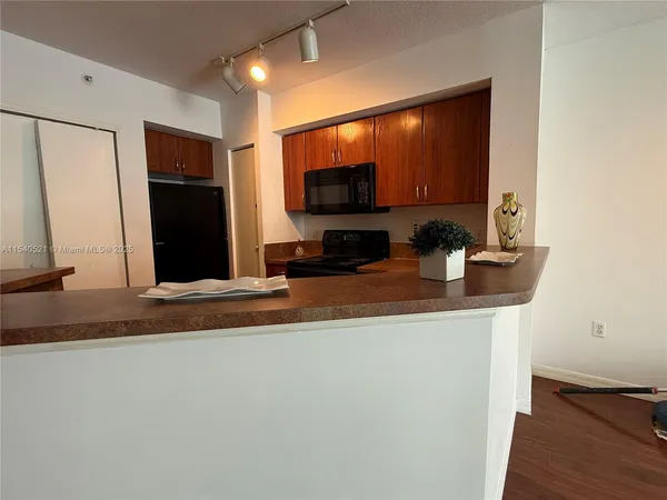 a kitchen with a sink and a refrigerator
