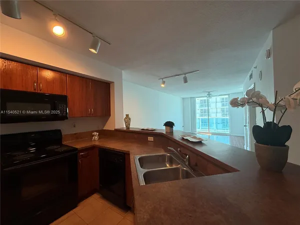 a kitchen with a sink and a stove top oven