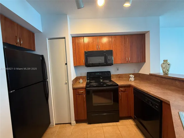 a kitchen with a refrigerator stove and microwave