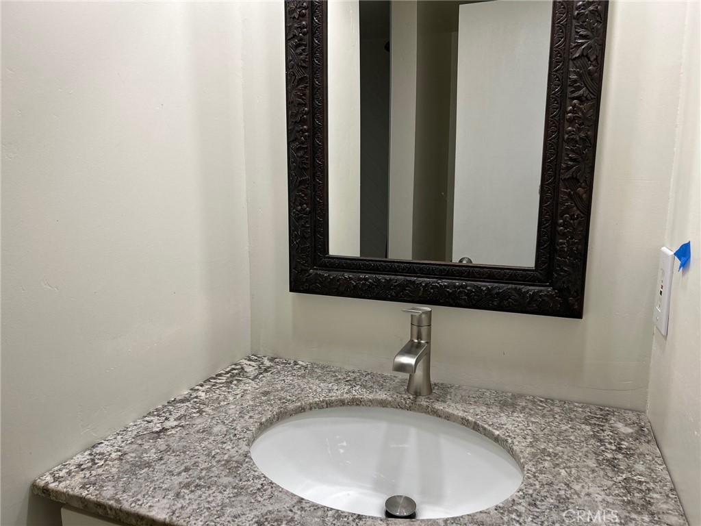 74443 Driftwood Drive, Unit 2 Palm Desert, CA 92260 - Photo 12 of 19 a bathroom with a sink and a mirror