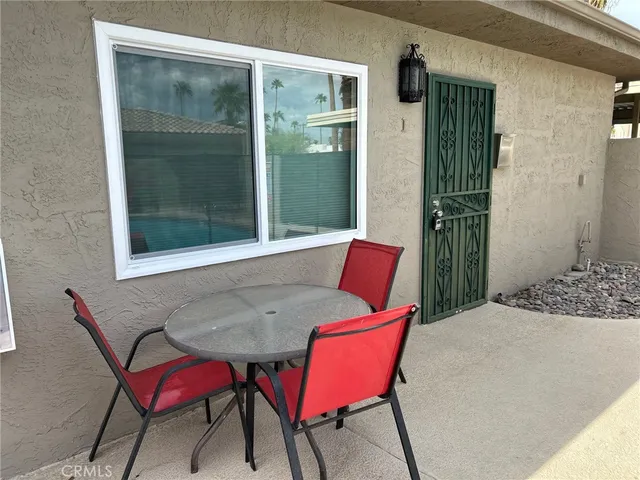 a balcony with table and chairs