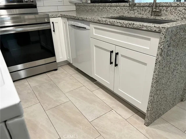 a stove top oven sitting inside of a kitchen