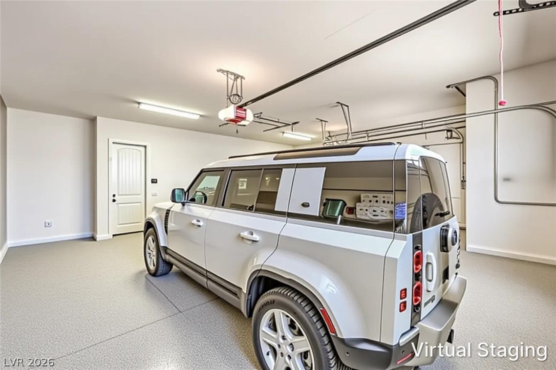 7119 Arabian Ridge Street Las Vegas, NV 89131 - Photo 63 of 73 A spacious garage features durable flooring and convenient overhead door openers.