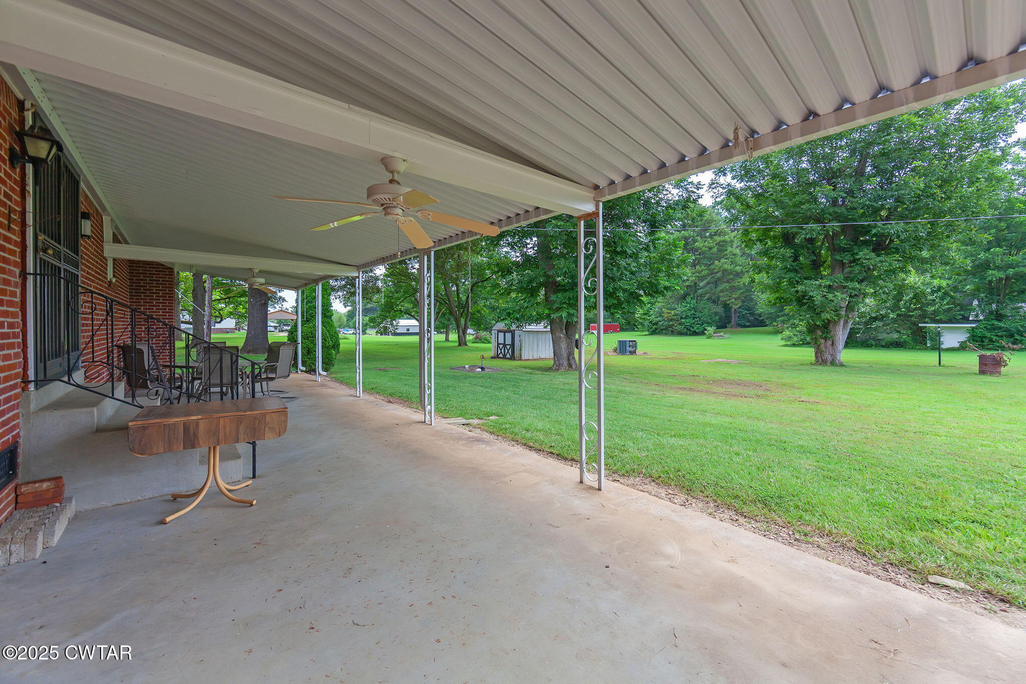 228 Gobelet Road Medon, TN 38356 - Photo 21 of 23 a view of a patio with table and chairs under a large umbrella