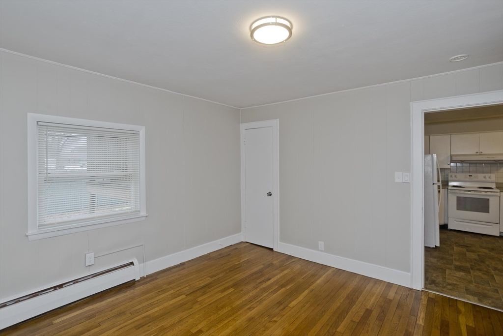 177 Marion Street Chicopee, MA 01013 - Photo 16 of 36 an empty room with wooden floor and windows