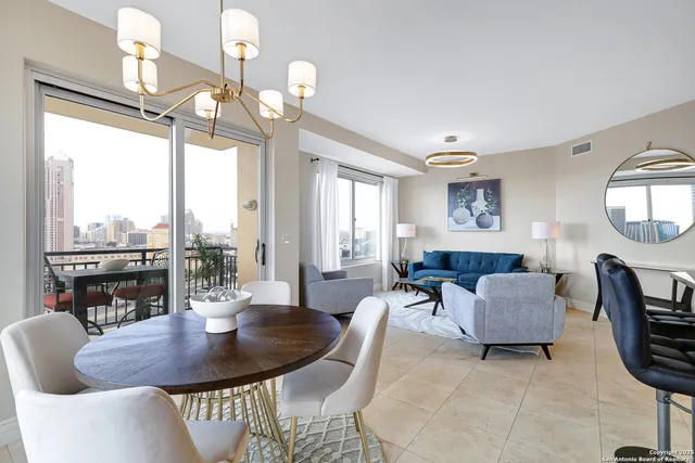 a living room with furniture a large window and a table