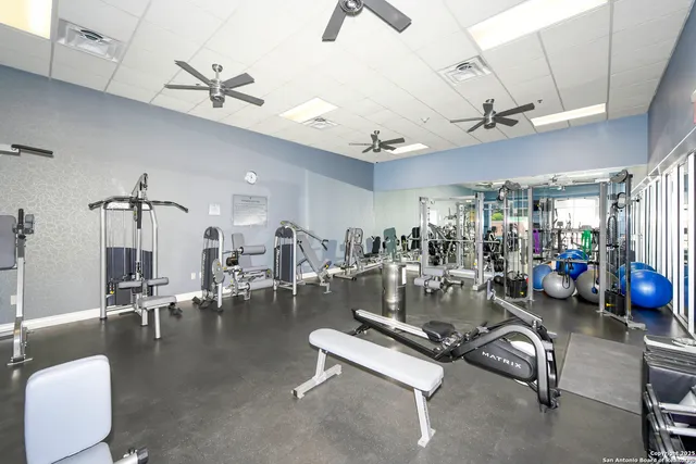 a living room with furniture a table and kitchen view