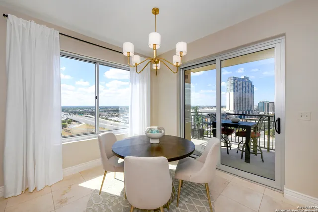 a dining room with furniture window and outdoor view