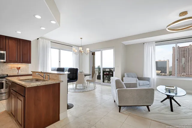 a kitchen with stainless steel appliances kitchen island granite countertop a sink and cabinets