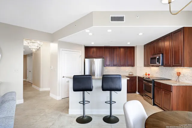 a bathroom with a granite countertop sink mirror vanity and toilet