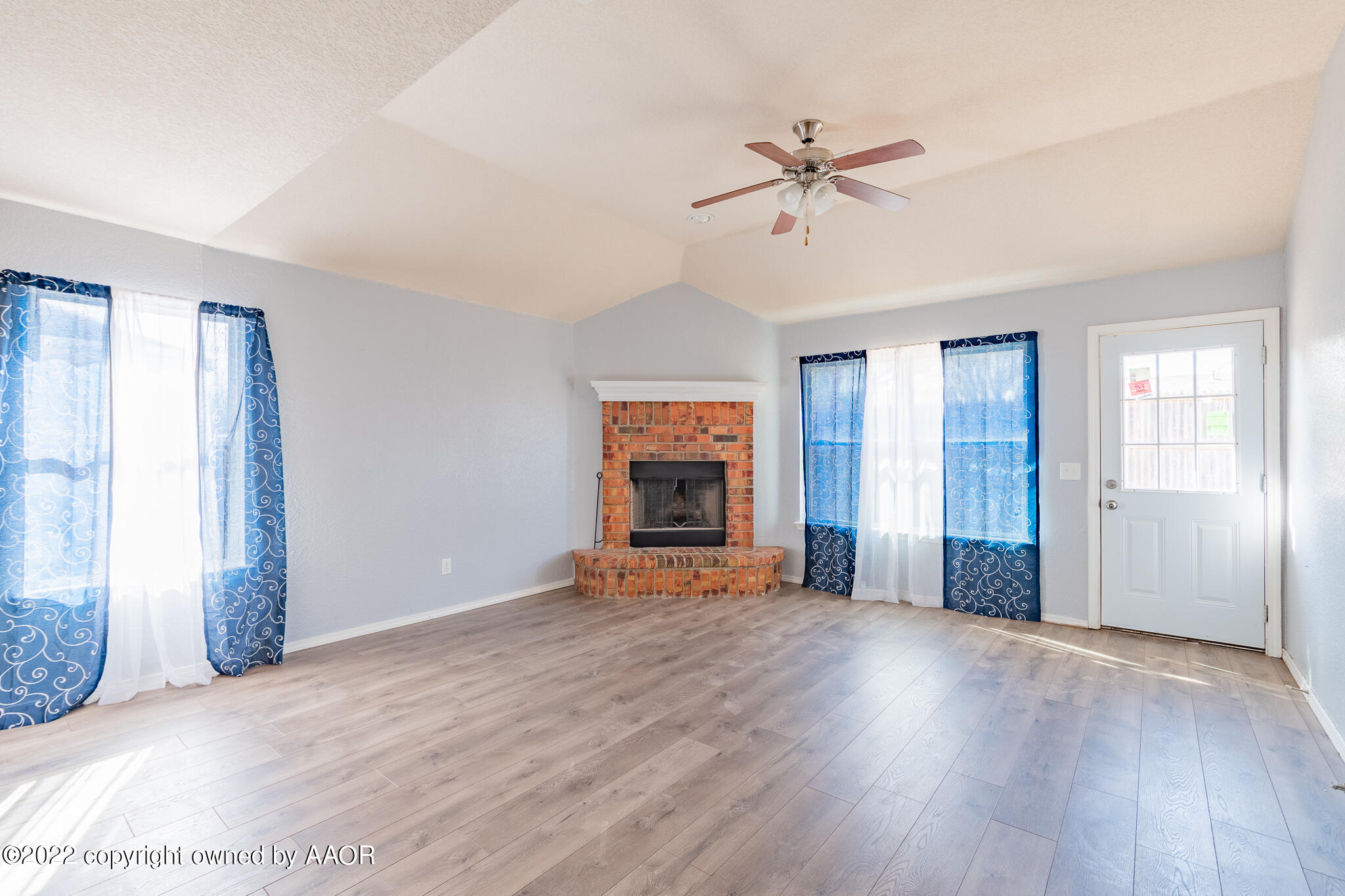 4726 Capulin Lane Amarillo, TX 79110 - Photo 11 of 28 a view of an empty room with window and wooden floor